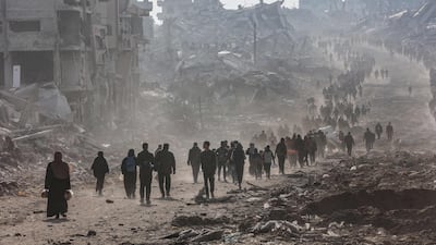 Palestinians leave Jabalia and areas surrounding Gaza city to walk back to their homes in the northern Gaza Strip on Sunday morning. AFP