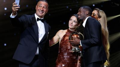 Ousmane Dembele and Aitana Bonmati pose for a selfie alongside former Netherlands footballer Ruud Gullit. AFP