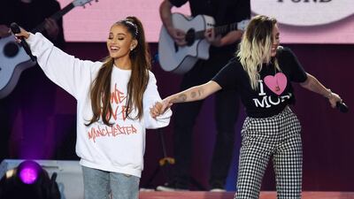 Ariana Grande, left, and Miley Cyrus perform at the One Love Manchester benefit concert for the families of the victims of the Manchester terror attack at Emirates Old Trafford. AFP Photo / One Love Manchester / Dave Hogan
