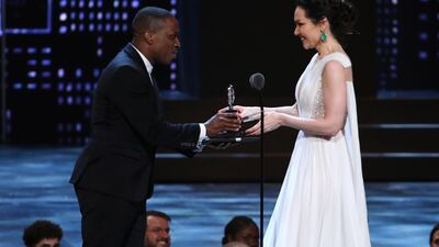 Katrina Lenk, right, accepts the award for leading actress in a musical for "The Band's Visit" from presenter Leslie Odom Jr. Michael Zorn / Invision / AP