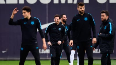 Lionel Messi looks on alongside teammates during a Barcelona training session. David Ramos / Getty Images