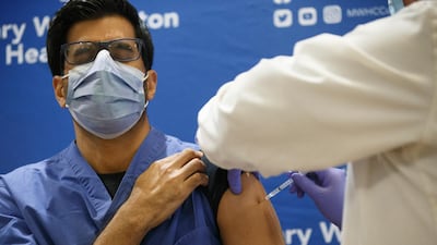 Dr. Rohit Goyal receives one of the first locally-available doses of the Pfizer-BioNTech COVID-19 vaccine at Mary Washington Hospital in Fredericksburg, Virginia. AP