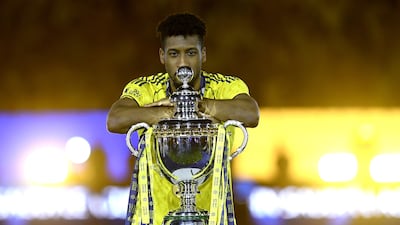 Al Nassr forward Kingsley Coman poses with the trophy. EPA