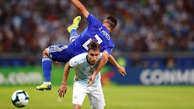 Paraguay's Ivan Piris, top, vies for the ball with Argentina's Nicolas Tagliafico. EPA