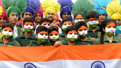 Indian school children pose with the national flag in Amritsar. Narinder Nanu / AFP