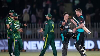 New Zealand's Mark Chapman, second right, celebrates with James Neesham after their win over Pakistan in the third T20 in Rawalpindi on Sunday. AP