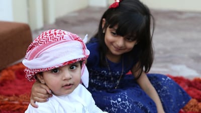 The touch of love and hope of life: Hussa, 4, gently embraces her 11-month-old baby brother Theyab, who in a few months will be helping to save her life by donating his stem cells to her. Ravindranath K / The National