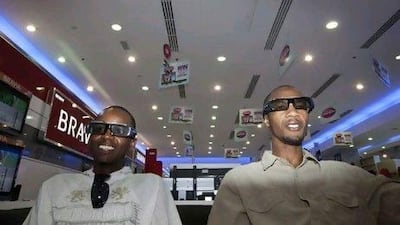 Two customers watch a 3D television at the Jumbo Electronics store in Mall of the Emirates.