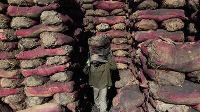 An Afghan labourer works at a charcoal shop in Kabul, Afghanistan, on November 16, 2015. With winter approaching, the prices of wood and charcoal are increasing in the country. Rahmat Gul / Associated Press