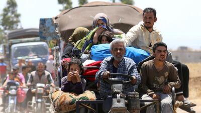 Internally displaced people from Deraa province arrive near the Israeli-occupied Golan Heights in Quneitra. REUTERS/Alaa Al-Faqir