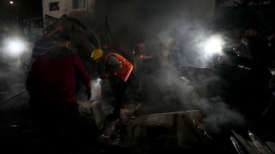 Palestinian firefighters try to extinguish a fire at Al Aqsa Hospital in Deir Al Balah. A million people are sheltering from Israeli military operations in that part of Gaza. AP