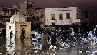 People wade through the Moroccan coastal city of Safi after a flash flood that killed at least 21 people and injured more than 30 others. All photos: AFP