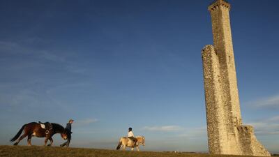 Two people ride horses next to the middle ages tower of Castelnau de Levis, Southern France, on December 27, 2015. According to reports, 2015, ranks fourth among the warmest years in France since records began in 1900, behind 2014, 2011 and 2003. Guillaume Horcajuelo / EPA
