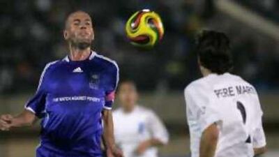 Zinedine Zidane, left, of France and Pere Marti of Spain battle for the ball during the "Match Against Poverty".