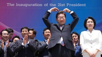 South Korea's President Lee Jae-myung makes a heart gesture to people outside the National Assembly in Seoul following his inauguration. AFP