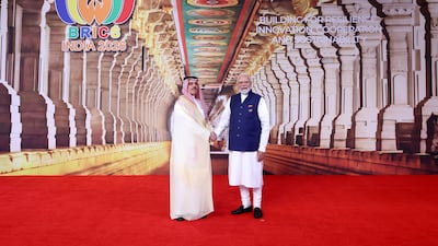 Saudi Foreign Minister Prince Faisal bin Farhan with Mr Modi on the final day of the Brics Summit in India's capital city. EPA
