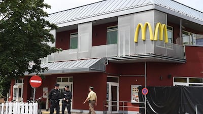 Policemen stand in front of the McDonald's that was the scene of Ali David Sonboly's shooting rampage on July 23, 2016. Christof Stache/AFP