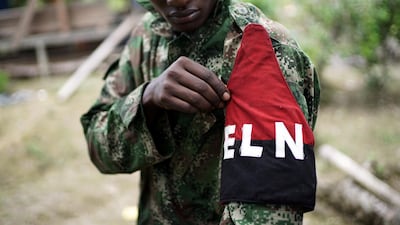 A rebel fighter with Colombia's Marxist National Liberation Army (ELN) shows his armband while posing for a photograph, in the country's northwestern jungles on August 31, 2017. Federico Rios / Reuters