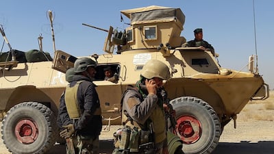 Afghan security forces stand near an armoured vehicle during clashes with Taliban fighters on the outskirts of Lashkar Gah, the capital of Helmand province, on May 5, 2021. AFP