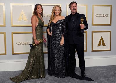 Pippa Ehrlich, left, and James Reed, right, pose in the press room with the award for best documentary feature for 'My Octopus Teacher' with Marlee Matlin. AP