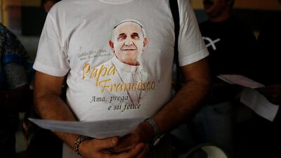 A man wearing a T-shirt with an image of Pope Francis attends Good Friday prayers at a church in Kolkata. Rupak De Chowdhuri / Reuters