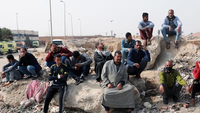 Relatives of workers stand near the site of a textile factory after a fire broke out in Obour industrial district, outskirts of Cairo, Egypt. At least 20 people died and 24 were injured after a fire broke out in a textile factory northeast of Cairo, local authorities reported after controlling the fire. EPA