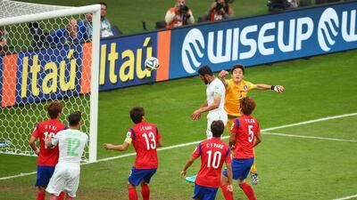 Rafik Halliche of Algeria scores his team's second goal on a header past Jung Sung-Ryong of South Korea during their match on Sunday at the 2014 World Cup. Paul Gilham / Getty Images