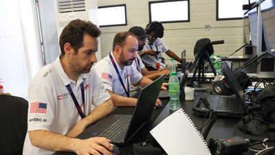 Coders hard at work to prep a car ahead of Saturday's inaugural race.