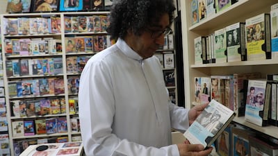 Ali Nasser holds the cherished copy of 'Life or Death' that inspired the creation of his Video Club Museum. Photo: Wajod Alkhamis / The National