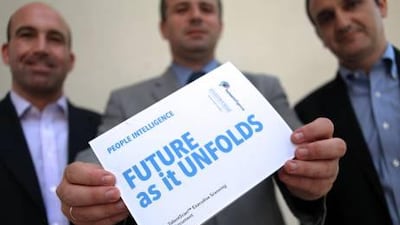 Scott Kaufman, the chief executive of Humantelligence, left, Panos Manolopoulos, the vice-chairman regions of Stanton Chase International, centre, and Yiannis Lagos, the president for international markets at Humantelligence. Rich-Joseph Facun / The National