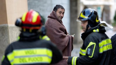 A man covers himself with a blanket after the earthquake in Visso, central Italy, October 27, 2016. Max Rossi/Reuters
