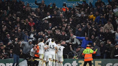 Stuart Dallas is mobbed by Leeds teammates after scoring their second goal. Reuters
