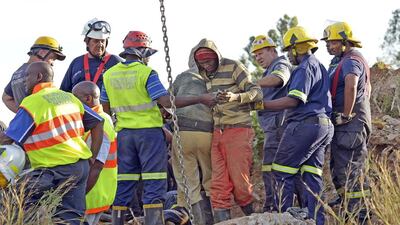 Rescuers tend to a mine worker after he was pulled out from an illegal gold mine in Benoni, outside Johannesburg, on February 16. Alexander Joe / AFP