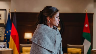 Queen Rania in an asymmetric Ferragamo coat in grey herringbone tweed. Photo: Ferragamo
