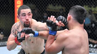 Robert Whittaker punches Kelvin Gastelum in a middleweight fight during the UFC Fight Night event at UFC APEX in Las Vegas, Nevada. Chris Unger/Zuffa LLC