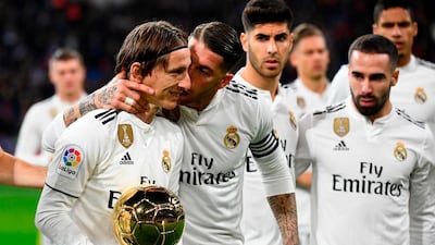 Real Madrid midfielder Luka Modric shows off his Ballon d'Or trophy before the Primera Liga match against Rayo Vallecano. AFP