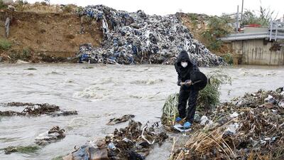 A Lebanese activist takes part in a campaign to clean the Beirut river from rubbish. Anwar Amro /AFP