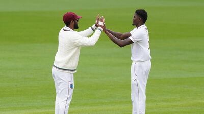 West Indies' Alzarri Joseph, right, celebrates the dismissal Joe Root. AP