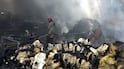Firefighters work at the site of a strike on a factory in Sanaa, Yemen. EPA