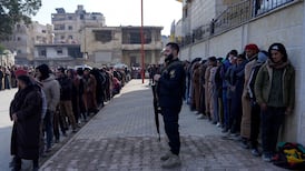 Members of the Kurdish-led SDF queue to settle their status with the Syrian government in Raqqa, Syria. Reuters