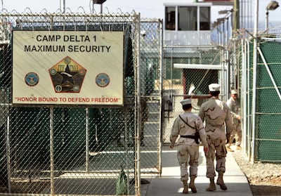 US military guards walk within Camp Delta military-run prison, at the Guantanamo Bay US Naval Base, Cuba. AP