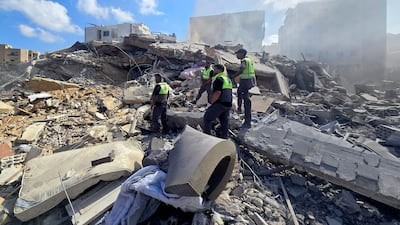Lebanese civil defence workers search through debris after an Israeli strike near the coastal city of Tyre. AFP