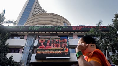 A news report on the Adani Group is broadcast on a screen outside the Bombay Stock Exchange in Mumbai. Bloomberg