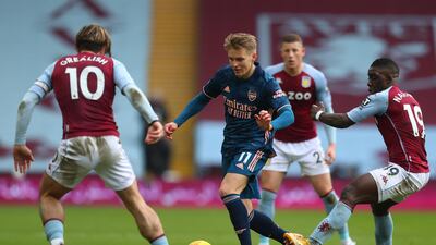 Arsenal midfielder Martin Odegaard under pressure from Aston Villa's Jack Grealish and Marvelous Nakamba. AFP