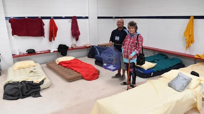 Bruthen residents stand in a relief centre at Bairnsdale City Oval after they were evacuated from their house which was threatened by fire. EPA