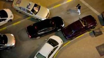 A man attempting to direct traffic outside a nightclub in Abu Dhabi highlights the problems associated with vehicle-oriented urban planning.