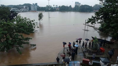 People gather on the banks of the overflowing Periyar River in the Aluva area of Kochi, Kerala, India. AFP