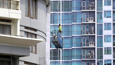 An worker cleans up a building in a central business area in Jakarta. Indonesia’s inflation rate rose 3.99 per cent in August from a year earlier. Mast Irham / EPA