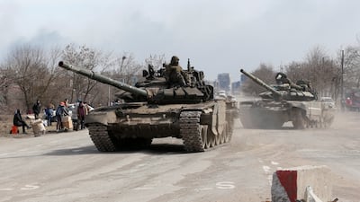 Pro-Russia militia fighters travel by tank to the outskirts of Mariupol. Reuters