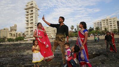 An Indian family takes a selfie on Mumbai’s coastline. India is home to the highest number of people who have died while taking photos of themselves, with 19 of the world’s 49 recorded selfie-linked deaths since 2014. Rafiq Maqbool / AP Photo